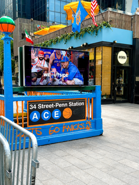 Penn Station entrance decorated in New York Knicks blue and orange during the teams 2026 playoff run.
