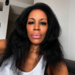 Natural hair after getting caught in the rain on a Sunday morning in New York City, wearing a white ribbed tank and embracing soft volume before running errands.