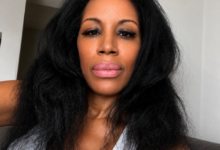 Natural hair after getting caught in the rain on a Sunday morning in New York City, wearing a white ribbed tank and embracing soft volume before running errands.