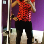 Full-length mirror photo featuring a bold red and black textured top paired with black pants and coordinating red high heels.