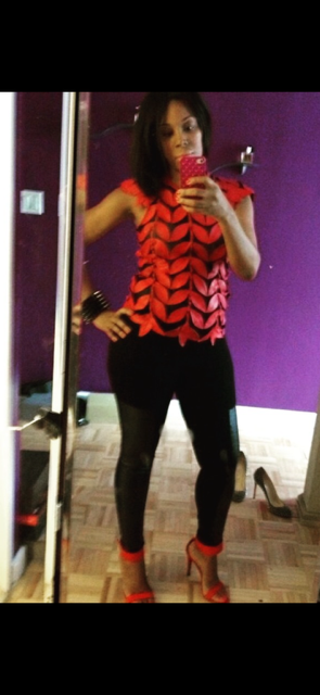 Full-length mirror photo featuring a bold red and black textured top paired with black pants and coordinating red high heels.