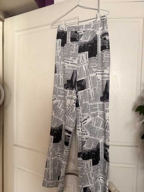 Black-and-white newspaper print wide-leg trousers featuring an all-over editorial print and high-waisted silhouette, completing the coordinated monochrome pantsuit.