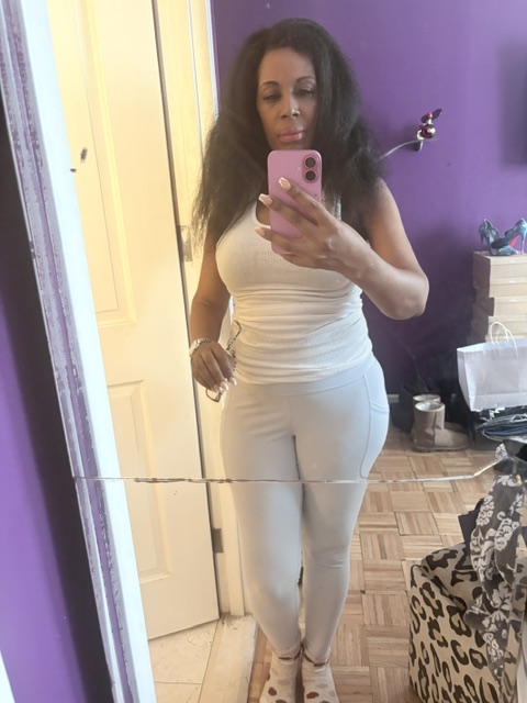 Full-body mirror selfie wearing a white ribbed tank and gray leggings with naturally voluminous hair after a rainy weekend, styled for Sunday errands in New York City.